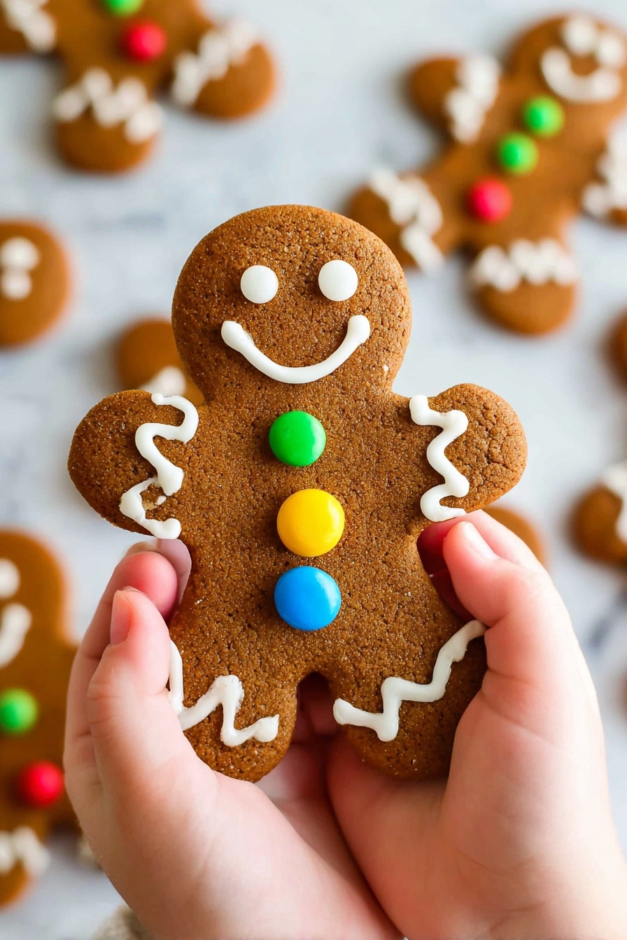 A pair of small hands hold a gingerbread cookie shaped like a person, decorated with white icing forming eyes, a smile, wavy lines on the arms and legs, and three round candy buttons in blue, red, and yellow stacked down the center of the body; in the background, more similarly decorated gingerbread cookies lie on a white marbled surface. photo taken with an iphone --ar 2:3 --v 7