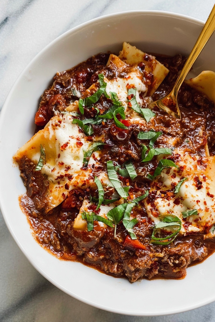 A white bowl filled with layered lasagna pieces covered in a thick, dark red meat sauce mixed with beans and small bits of vegetables. On top of the lasagna are several dollops of white ricotta cheese sprinkled with red seasoning, scattered fresh green basil leaves add a pop of color. A gold spoon rests inside the bowl on the right side. The bowls sit on a white marbled surface, with extra basil leaves and a small white bowl with red powder on the left and another bowl of ricotta cheese on the lower right corner. Photo taken with an iphone --ar 2:3 --v 7