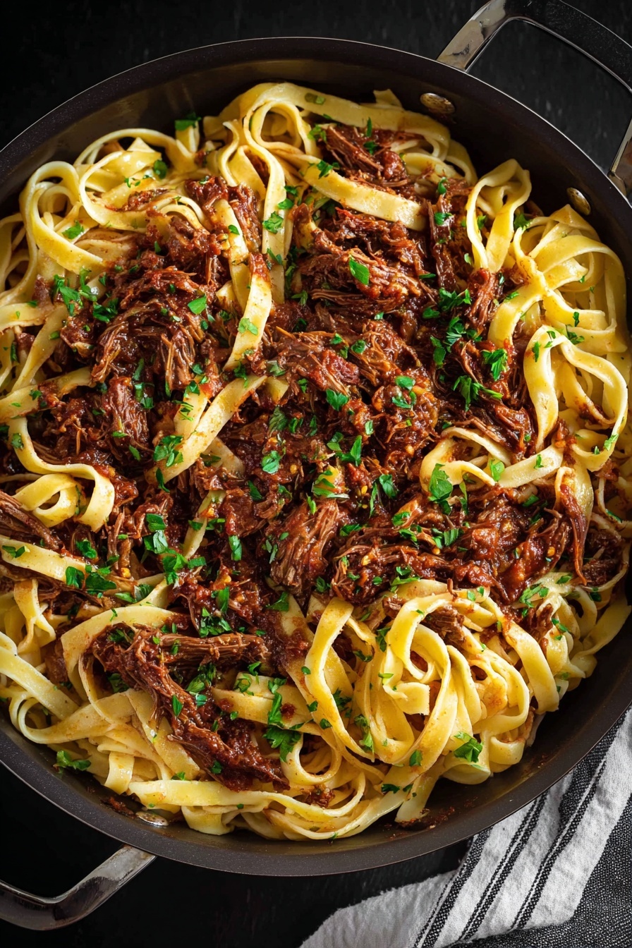 The dish is a bowl filled with wide, flat noodles mixed with chunks of shredded dark brown meat. The noodles are a pale yellow color and look soft, twisted around the meat in many layers. Bits of grated white cheese are sprinkled on top along with small pieces of bright green herbs, adding a fresh touch to the rich, saucy mix. A silver fork is placed inside the bowl on the right side, partially twirling some noodles. The bowl is white and sits on a white marbled surface. In the background, there is a small wooden bowl with light-colored cheese chunks. Photo taken with an iphone --ar 2:3 --v 7