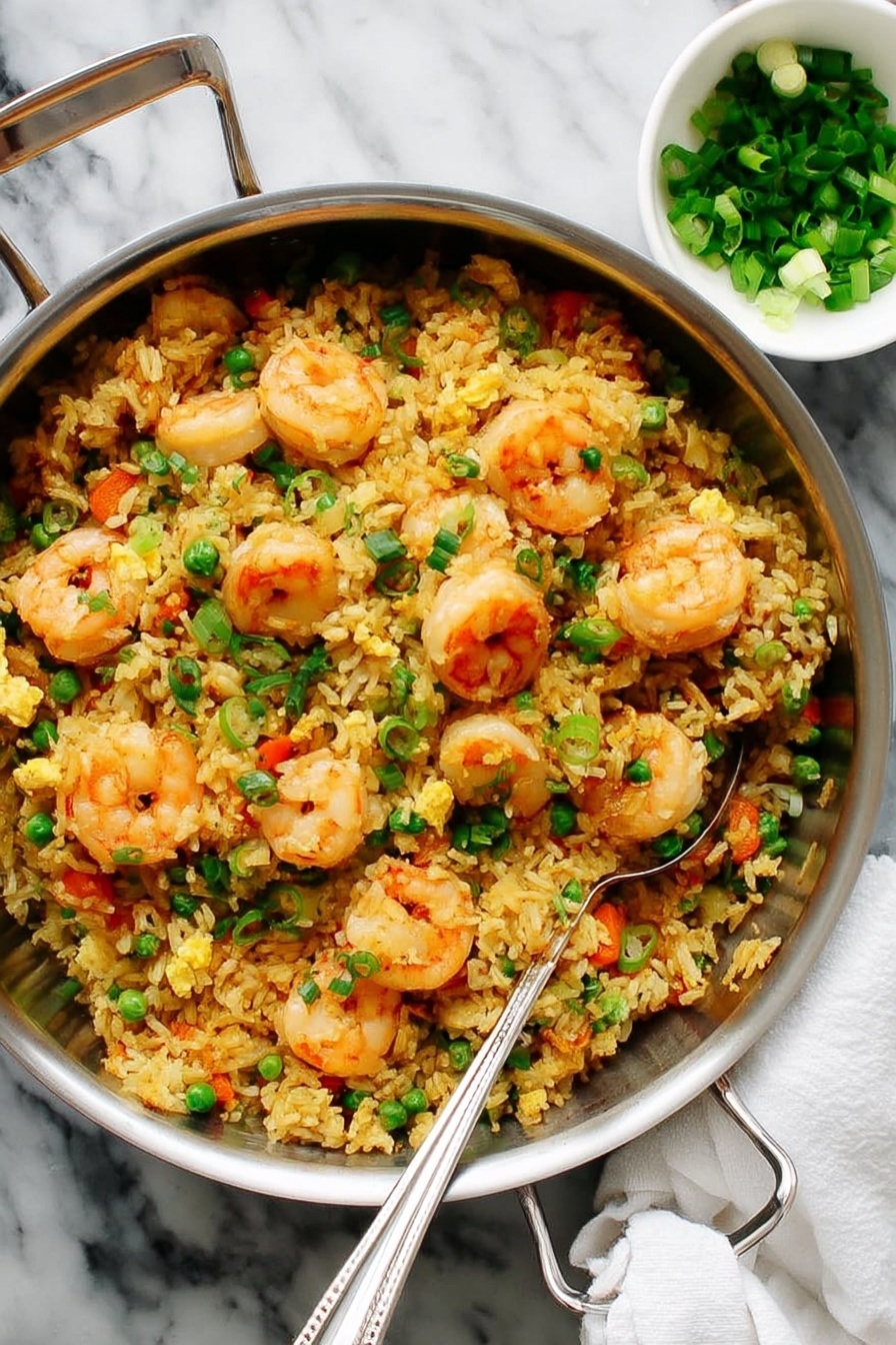 A large silver pan filled with a mix of fried rice and shrimp takes center stage, the rice showing a golden yellow color with small pieces of bright orange carrots, green peas, and scrambled egg pieces scattered evenly throughout. On top, large pink shrimp with a slightly curled shape are spread across the dish, giving it a fresh and inviting look. In the background, there is a small white bowl filled with chopped green onions, adding a touch of green to the white marbled surface beneath. A metal spoon rests on the edge of the pan, ready to serve the dish. photo taken with an iphone --ar 2:3 --v 7